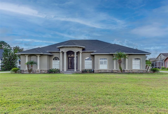 view of front of home featuring a garage and a front lawn