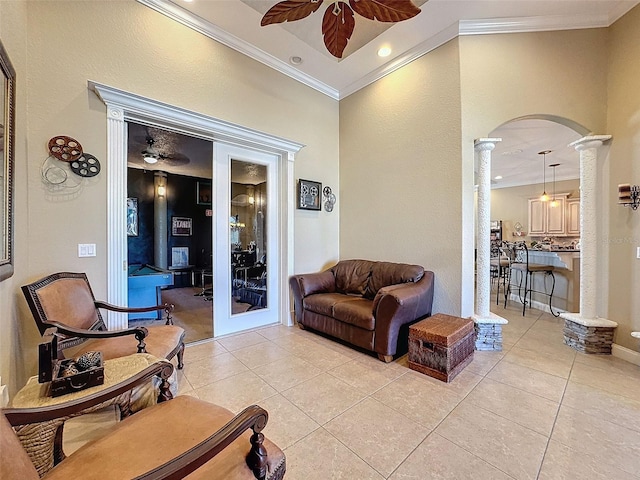 tiled living room featuring ornamental molding, ceiling fan, and ornate columns