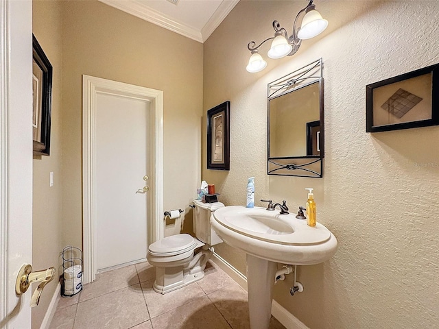 bathroom featuring tile patterned floors, ornamental molding, and toilet