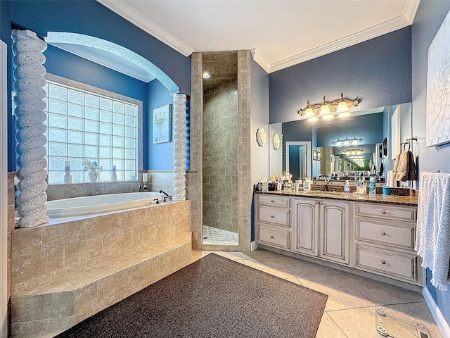 bathroom with ornate columns, plus walk in shower, ornamental molding, vanity, and tile patterned floors