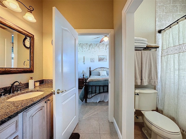 bathroom with a shower with curtain, tile patterned floors, toilet, and vanity