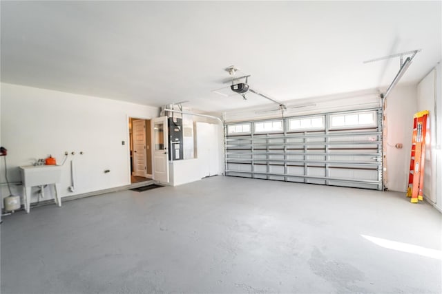 garage featuring a sink and a garage door opener