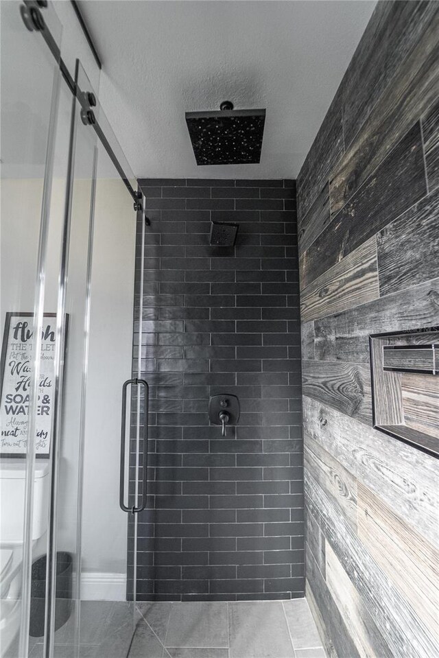 bathroom featuring a stall shower and a textured ceiling