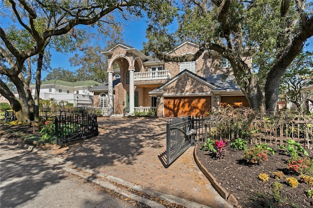 view of front of house featuring a garage and a balcony