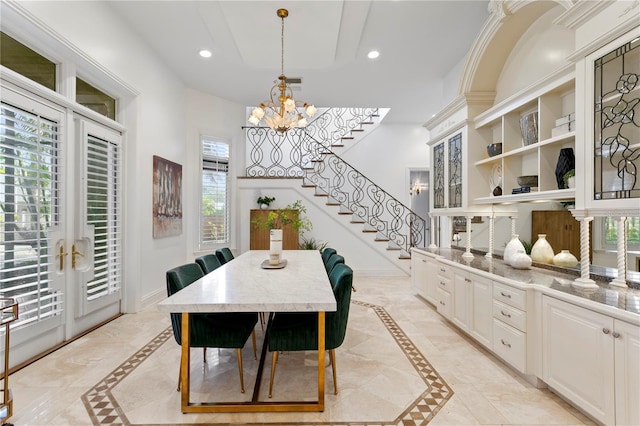 dining space with a chandelier and french doors