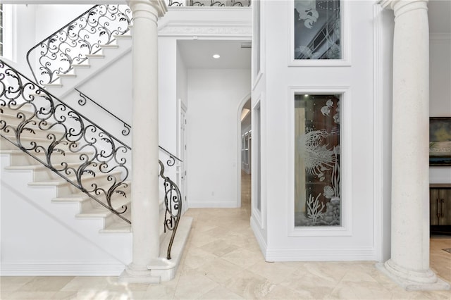 stairway featuring ornate columns