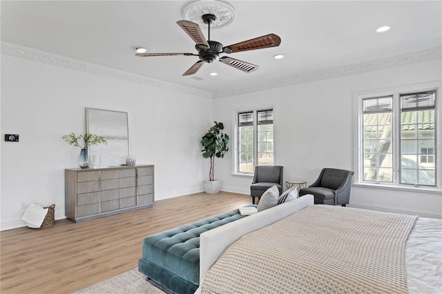 bedroom with crown molding, light hardwood / wood-style flooring, and ceiling fan