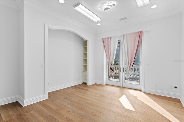 unfurnished room featuring ornamental molding and light hardwood / wood-style flooring