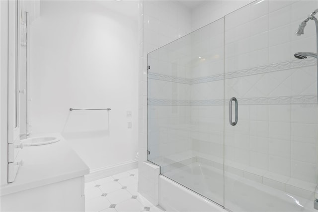 bathroom with vanity and bath / shower combo with glass door