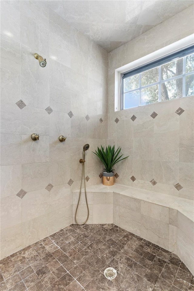 bathroom with a tile shower