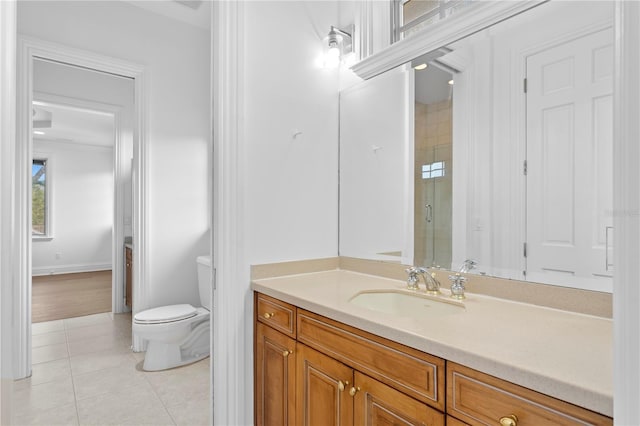 bathroom with tile patterned floors, toilet, an enclosed shower, and vanity