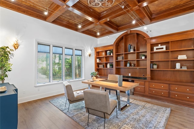 home office featuring coffered ceiling, beam ceiling, and light hardwood / wood-style flooring