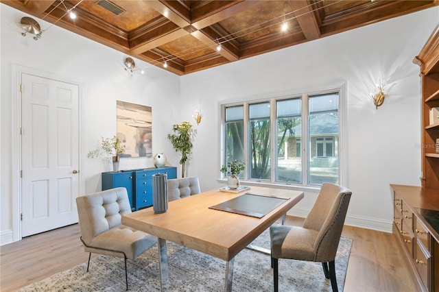 dining area with beamed ceiling, coffered ceiling, and light hardwood / wood-style flooring