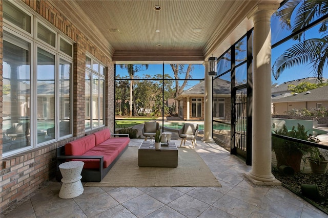 sunroom / solarium featuring wooden ceiling and decorative columns