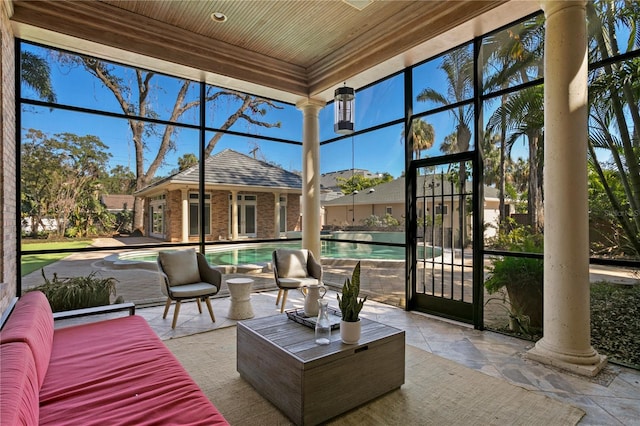 sunroom featuring wooden ceiling and ornate columns