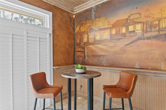 dining space with tile patterned floors and ornamental molding