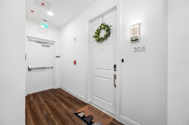 doorway with dark hardwood / wood-style floors