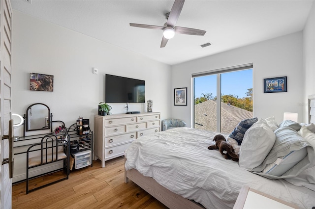 bedroom featuring light wood-type flooring, access to outside, visible vents, and ceiling fan