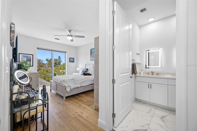 bedroom with marble finish floor, visible vents, a ceiling fan, connected bathroom, and a sink