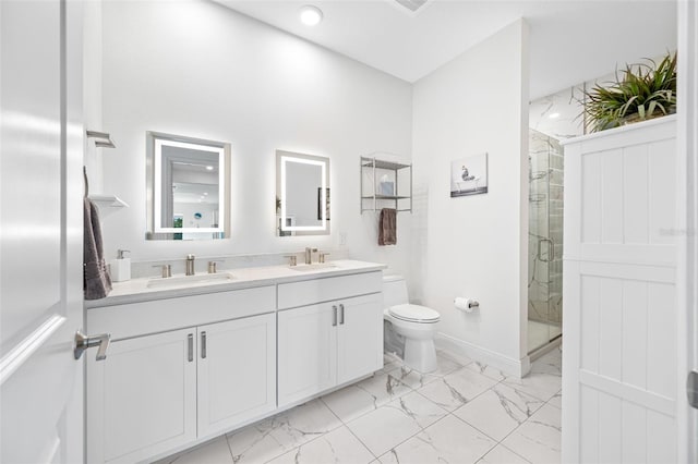 full bathroom with toilet, marble finish floor, a sink, and a stall shower