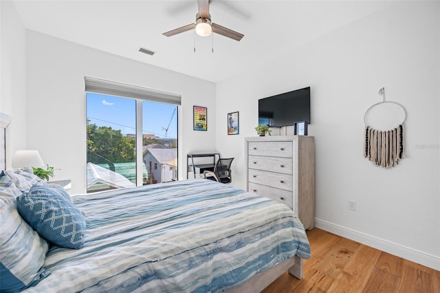 bedroom featuring ceiling fan, light wood-style flooring, visible vents, access to exterior, and baseboards