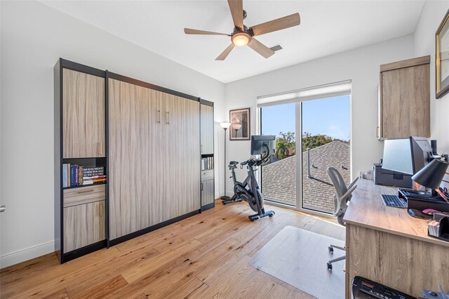 office area featuring light wood-type flooring, ceiling fan, visible vents, and baseboards