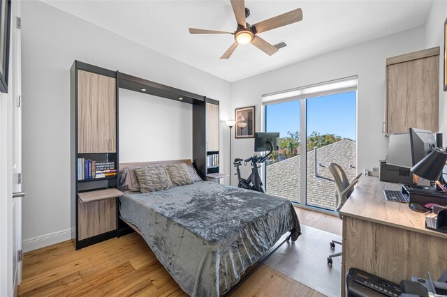 bedroom featuring access to exterior, light wood-type flooring, visible vents, and baseboards