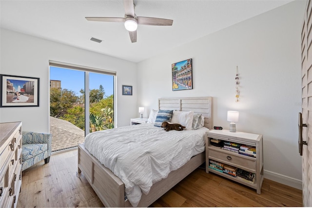 644 3rd Ave S Unit 305, Saint Petersburg, FL 33701 - bedroom with access to outside, wood finished floors, and a ceiling fan