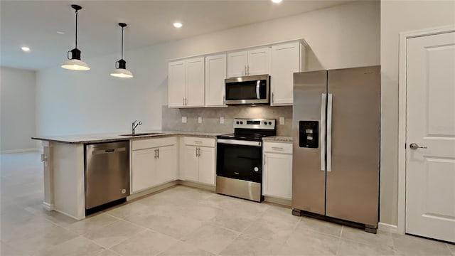 kitchen featuring sink, hanging light fixtures, kitchen peninsula, stainless steel appliances, and white cabinets