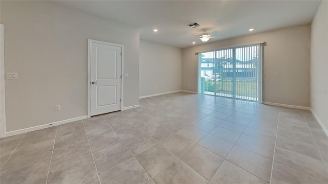 empty room featuring light tile patterned floors and ceiling fan