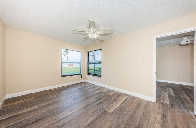 spare room with ceiling fan, dark hardwood / wood-style flooring, and a textured ceiling