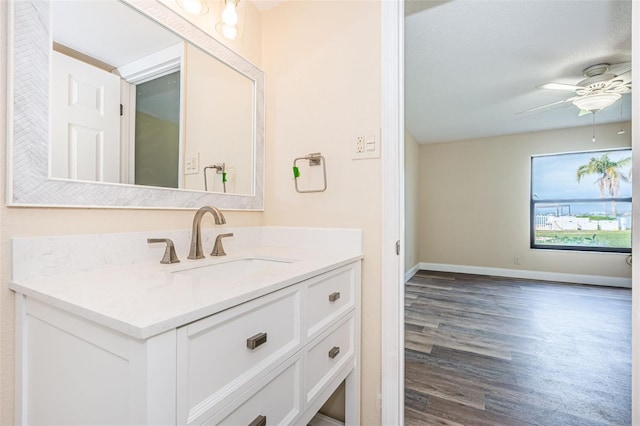 bathroom with ceiling fan, vanity, and hardwood / wood-style floors