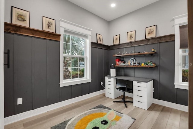 home office with light hardwood / wood-style floors