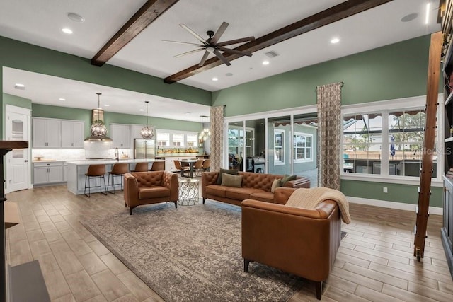 living room featuring visible vents, wood finish floors, a ceiling fan, and beam ceiling