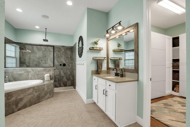 full bath with a walk in shower, vanity, and recessed lighting
