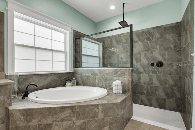 full bathroom featuring a walk in shower, tile patterned floors, and a bath