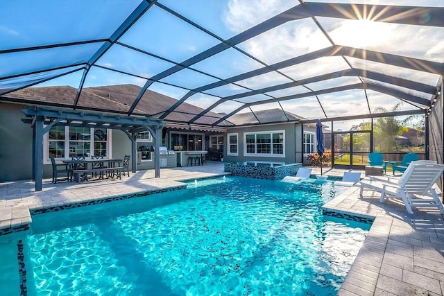 pool featuring outdoor dry bar, a patio area, and glass enclosure
