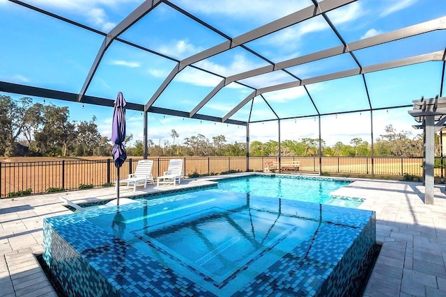 view of swimming pool featuring a patio area, a lanai, and fence