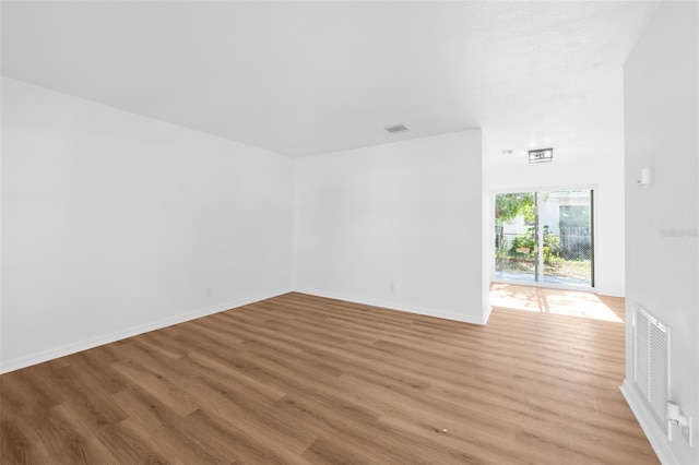 spare room featuring light hardwood / wood-style flooring