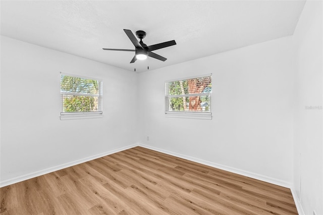 unfurnished room with ceiling fan and light hardwood / wood-style flooring