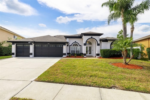 view of front of house featuring a garage and a front yard