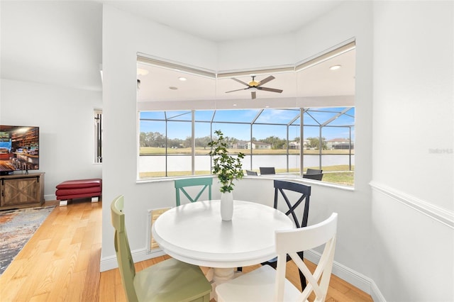 dining area with ceiling fan and light hardwood / wood-style floors