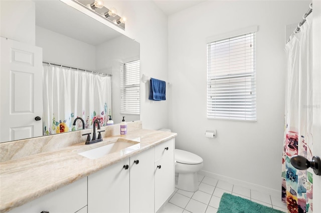 bathroom featuring tile patterned floors, vanity, and toilet