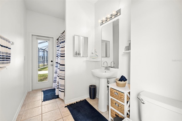 bathroom with tile patterned flooring, sink, and toilet