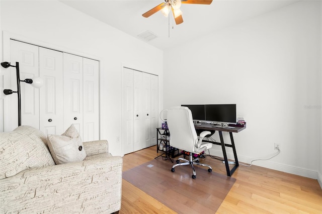 home office with hardwood / wood-style floors and ceiling fan