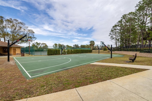 view of basketball court featuring a yard