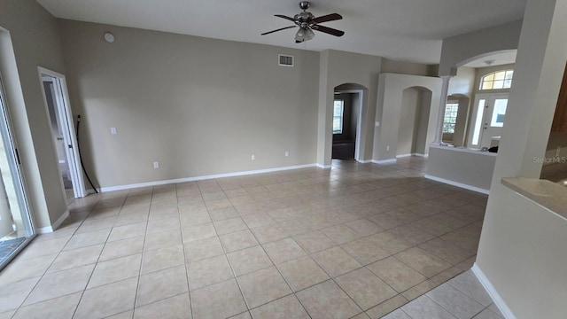 unfurnished living room featuring light tile patterned floors and ceiling fan