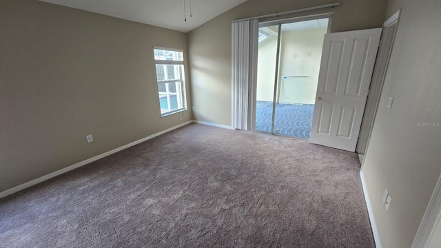 unfurnished room featuring vaulted ceiling and carpet