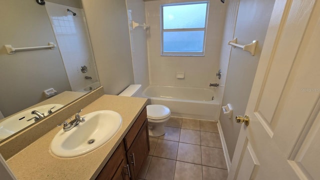 full bathroom with vanity, tiled shower / bath combo, tile patterned floors, and toilet