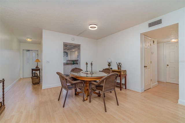 dining space with light wood-type flooring